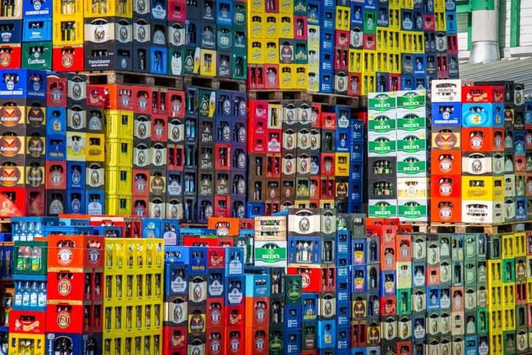 Stacked beer crates in different colors.